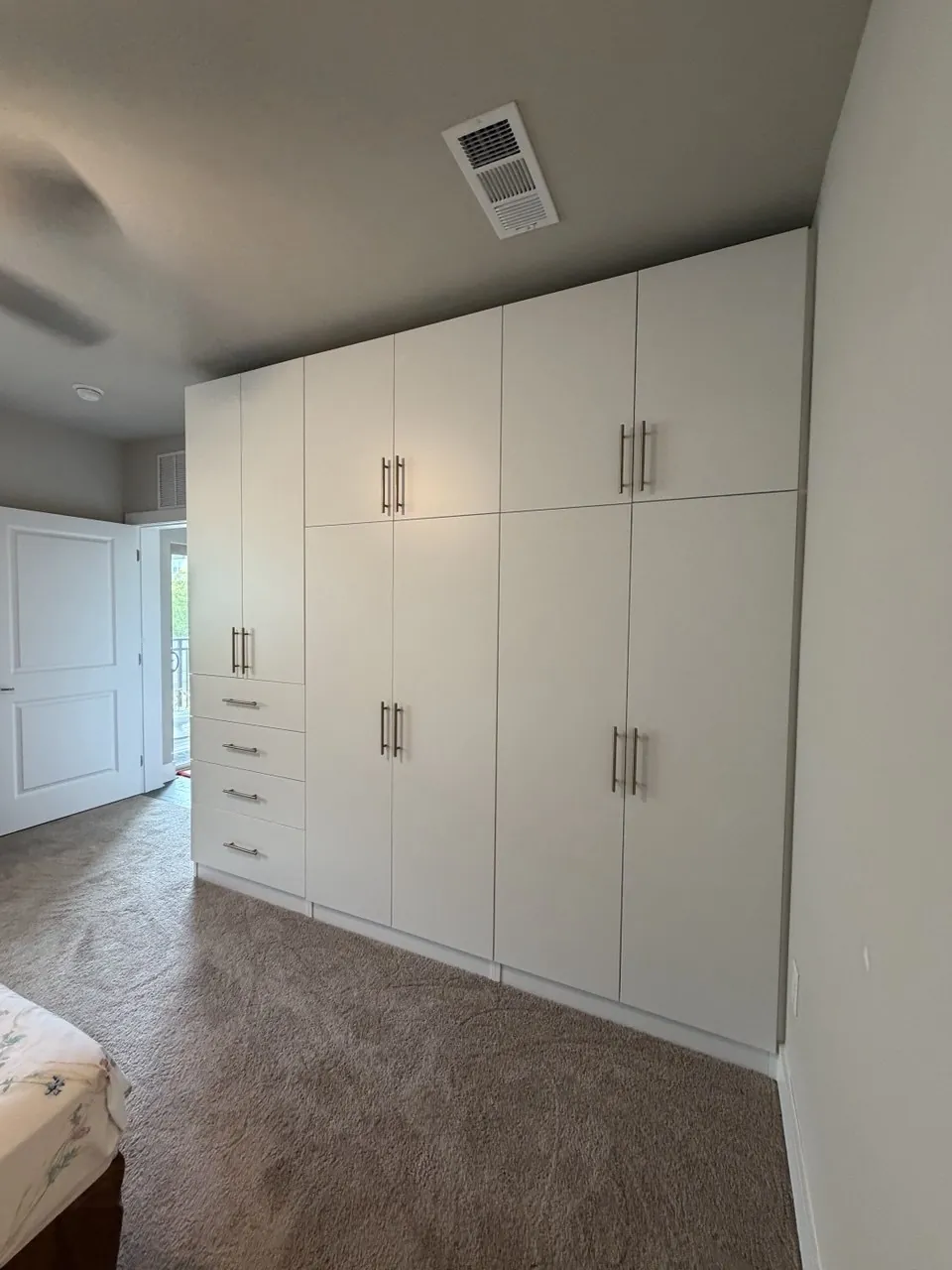 Floor-to-ceiling white reach-in wardrobe built into an Atlanta bedroom